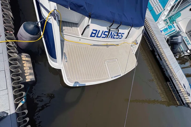Slide: The Image of 2007 Formula 330 Sun Sport docked, rear view with "BUSINESS" name visible. - 13