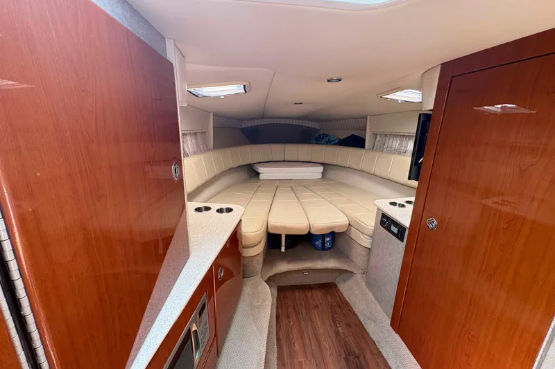 Slide: The Image of Interior of 2007 Formula 330 Sun Sport boat with cozy seating and wood accents. - 15