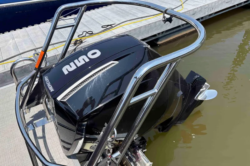 Slide: The Image of 2023 Crest Classic DLX 220 boat with Mercury outboard engine at dock. - 17