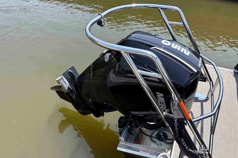 Slide: The Image of 2023 Crest Classic DLX 220 boat with Mercury outboard motor on water. - 13