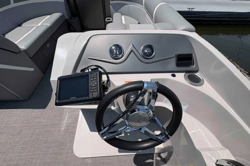 Slide: The Image of 2023 Crest Classic DLX 220 boat dashboard with steering wheel and navigation system. - 9