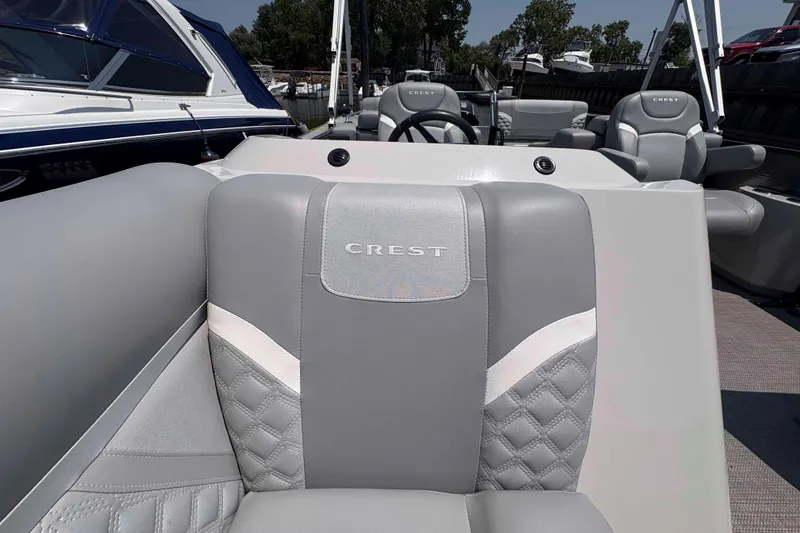 Slide: The Image of 2023 Crest Classic DLX 220 boat interior with luxurious gray seating and elegant design. - 8