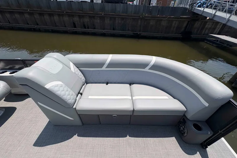 Slide: The Image of 2023 Crest Classic DLX 220 pontoon boat with elegant gray seating and modern design. - 5
