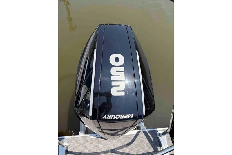 Slide: The Image of 2023 Crest Classic DLX 220 boat with Mercury outboard engine on water. - 15