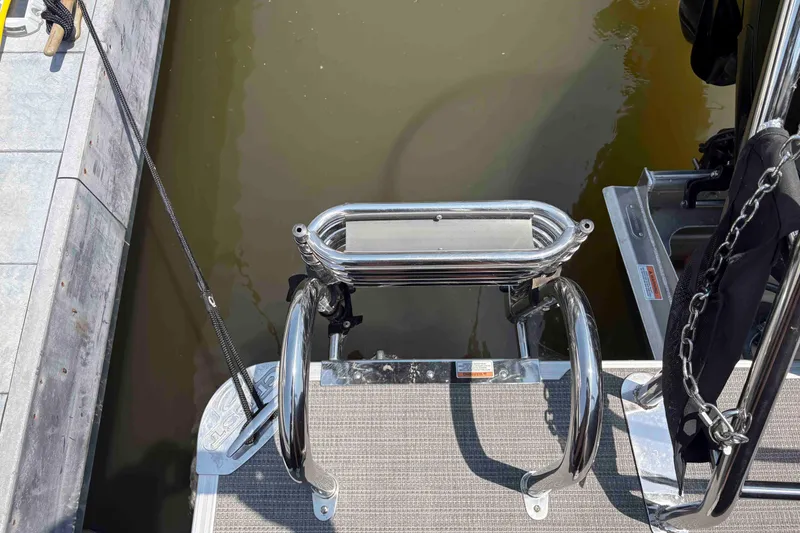 Slide: The Image of 2023 Crest Classic DLX 220 boat ladder and dock, featuring stainless steel rails. - 14