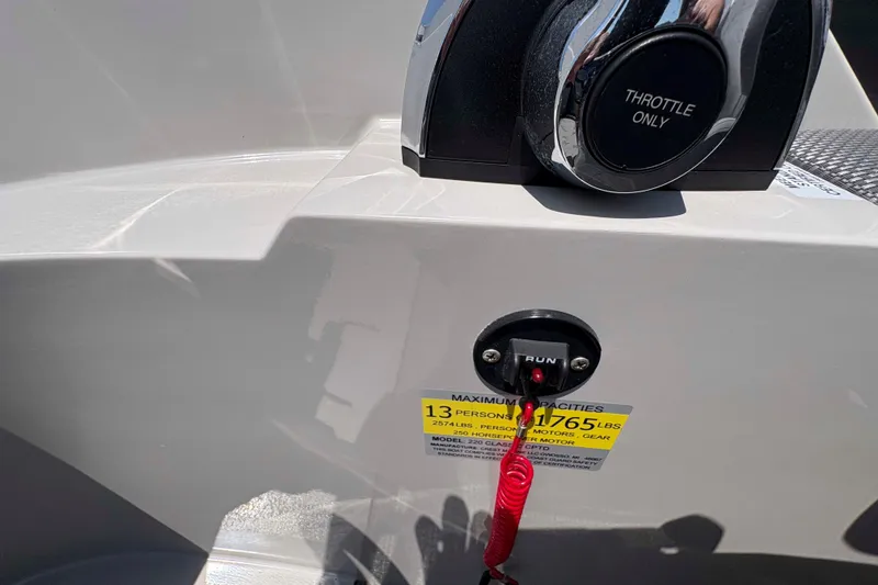 Slide: The Image of Throttle control and safety switch on 2023 Crest Classic DLX 220 boat. - 19