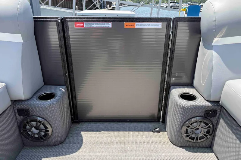 Slide: The Image of 2023 Crest Classic DLX 220 boat interior with speakers and cup holders. - 27