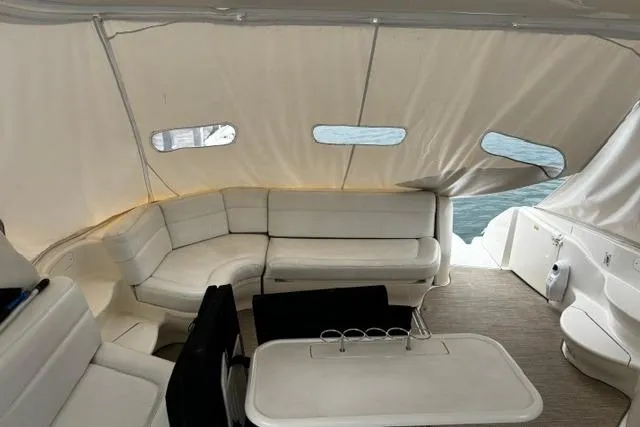 Slide: The Image of Interior of 2003 Sea Ray 550 Sundancer yacht with white seating and table. - 24