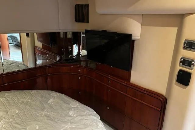 Slide: The Image of Luxurious interior of 2003 Sea Ray 550 Sundancer yacht with elegant wood cabinetry and TV. - 16