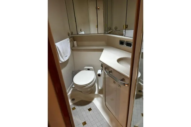 Slide: The Image of Bathroom interior of a 2003 Sea Ray 550 Sundancer yacht, featuring a compact design. - 21