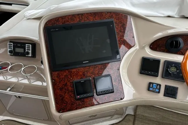 Slide: The Image of Control panel of a 2003 Sea Ray 550 Sundancer yacht with navigation screens. - 25