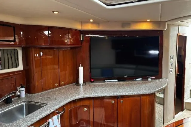 Slide: The Image of Luxurious interior of 2003 Sea Ray 550 Sundancer yacht with sleek cabinetry and modern amenities. - 18