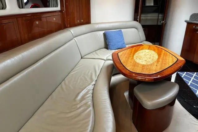 Slide: The Image of Luxurious interior of 2003 Sea Ray 550 Sundancer with leather seating and elegant wooden table. - 17