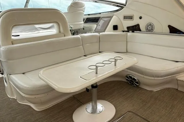 Slide: The Image of Interior of 2003 Sea Ray 550 Sundancer yacht with white seating and table. - 33