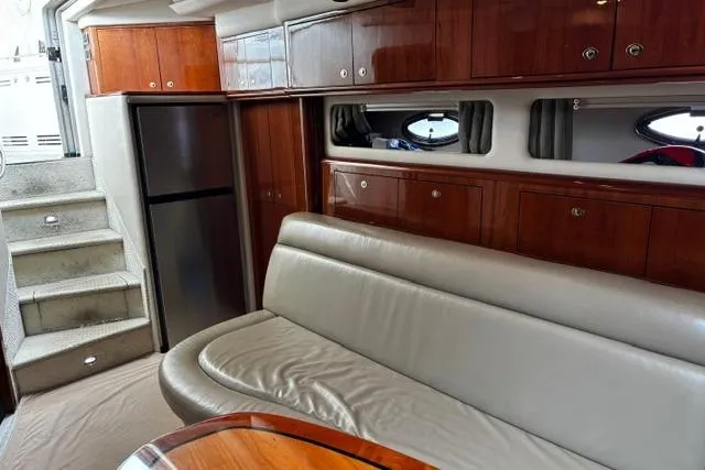 Slide: The Image of Luxurious interior of 2003 Sea Ray 550 Sundancer yacht with leather seating and wooden cabinetry. - 23