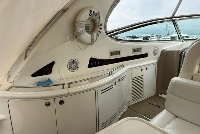 Slide: The Image of Interior view of 2003 Sea Ray 550 Sundancer yacht with white seating and cabinetry. - 29
