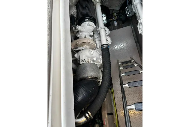 Slide: The Image of Engine compartment of a 2003 Sea Ray 550 Sundancer with visible components and ladder. - 13