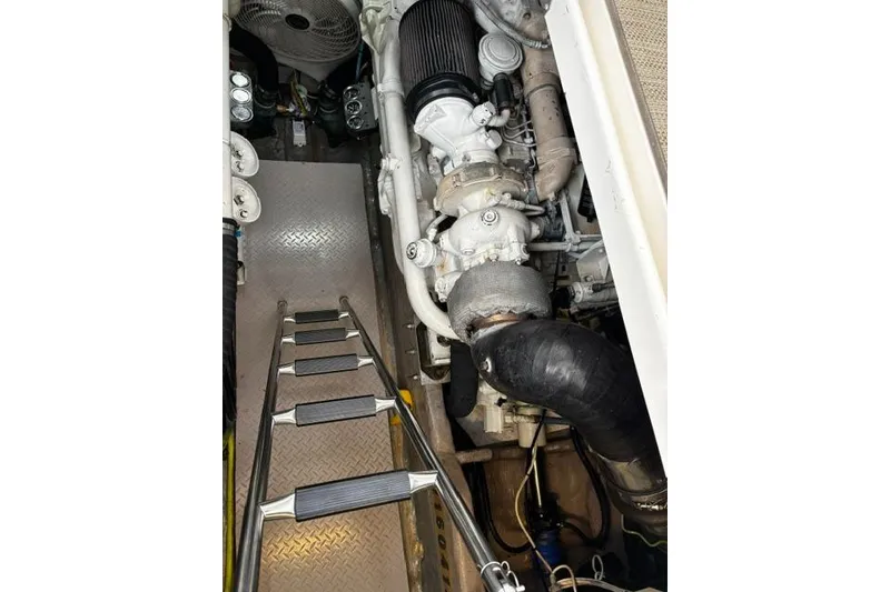 Slide: The Image of Engine room of 2003 Sea Ray 550 Sundancer with visible components and ladder. - 14