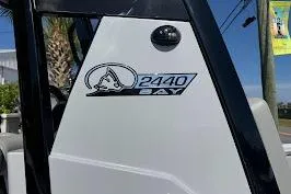 Slide: The Image of 2027 Blazer Bay 2440 boat logo on white exterior with blue sky background. - 6