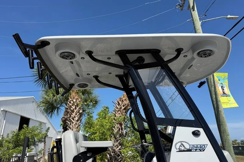 Slide: The Image of 2027 Blazer Bay 2440 boat with T-top and speakers, set against a clear blue sky. - 9