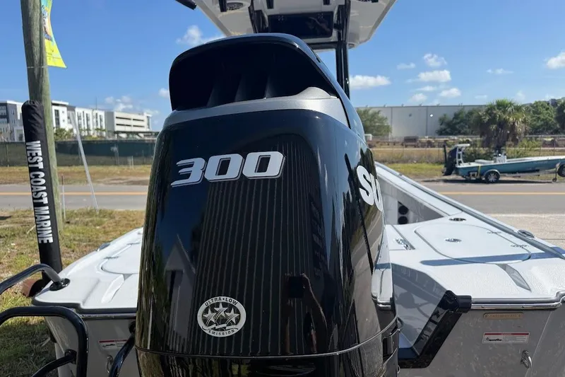 Slide: The Image of 2027 Blazer Bay 2440 boat with powerful 300 horsepower engine, parked outdoors. - 11