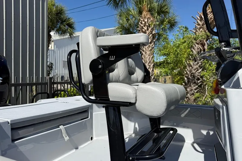 Slide: The Image of 2027 Blazer Bay 2440 boat interior with cushioned seating and steering console. - 7