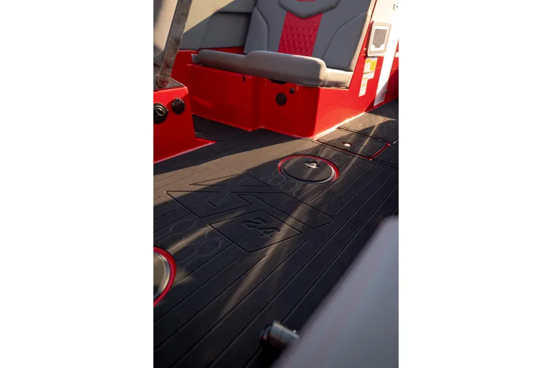 Slide: The Image of Interior view of 2027 MasterCraft XT24 boat with red and gray seating. - 23