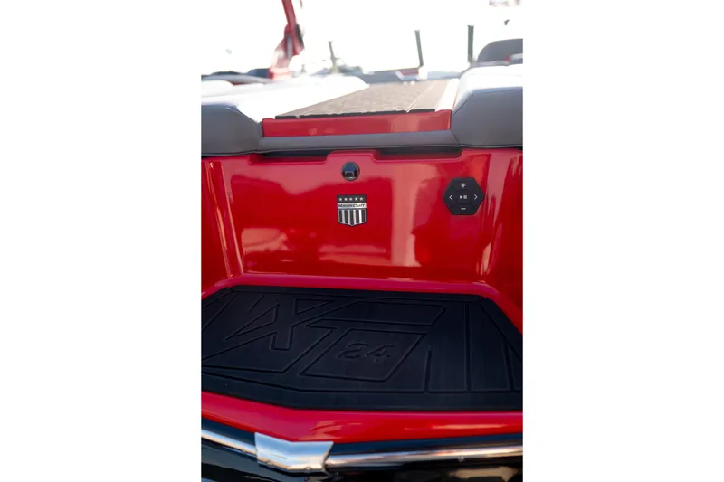 Slide: The Image of 2027 MasterCraft XT24 boat rear view with red finish and control panel. - 10