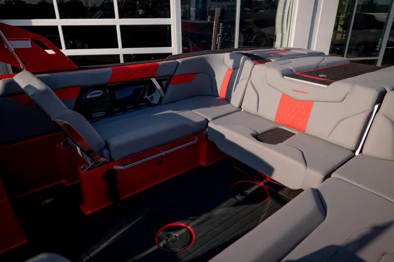 Slide: The Image of 2027 MasterCraft XT24 boat interior with red and gray seating, showcasing modern design. - 28