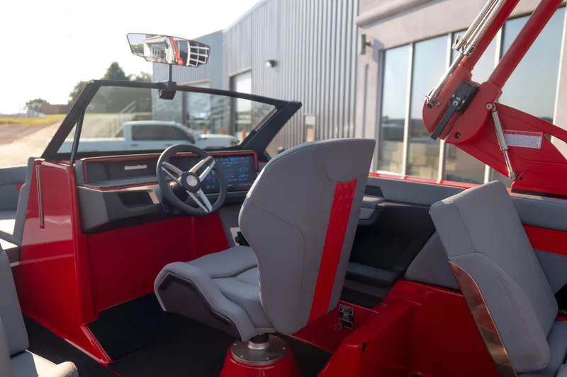 Slide: The Image of 2027 MasterCraft XT24 boat interior with modern dashboard and sleek red accents. - 24