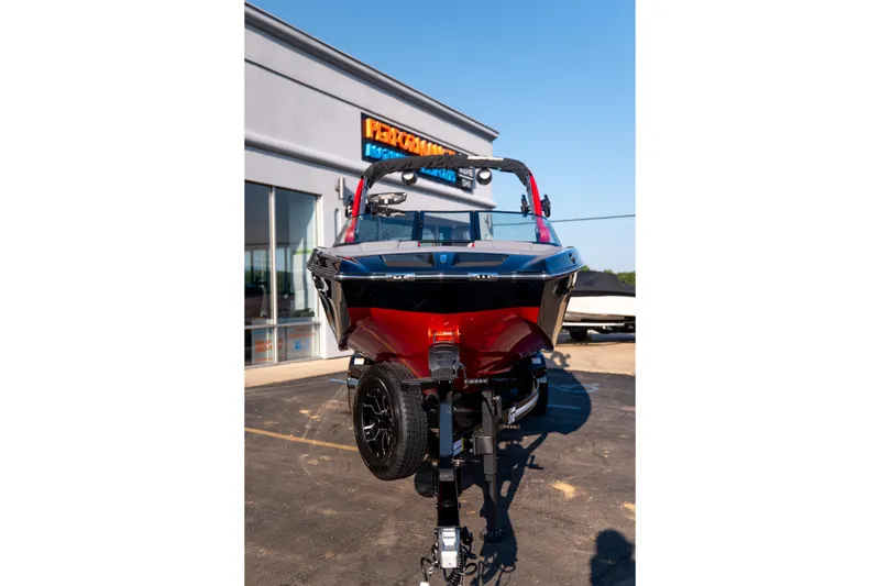 Slide: The Image of 2027 MasterCraft XT24 boat on trailer outside dealership. - 16