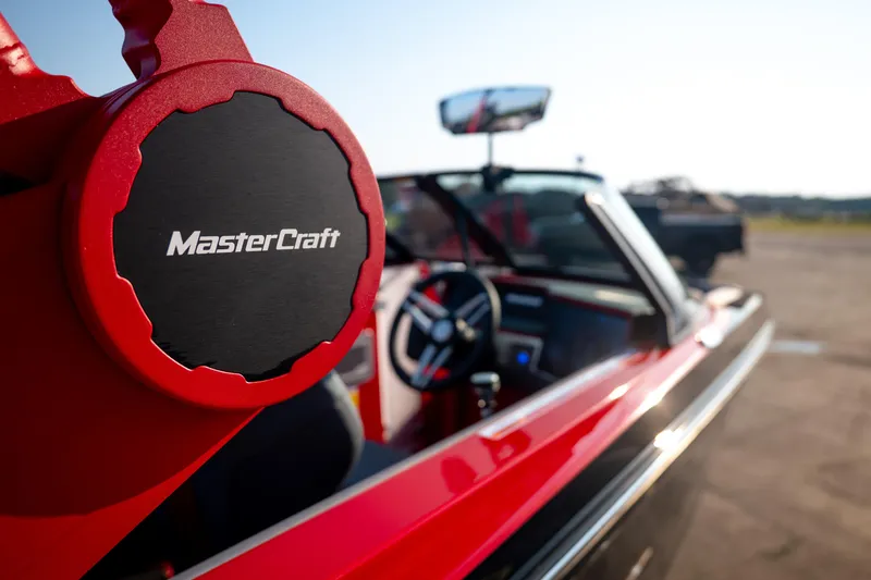 Slide: The Image of 2027 MasterCraft XT24 boat interior with steering wheel and logo detail. - 14