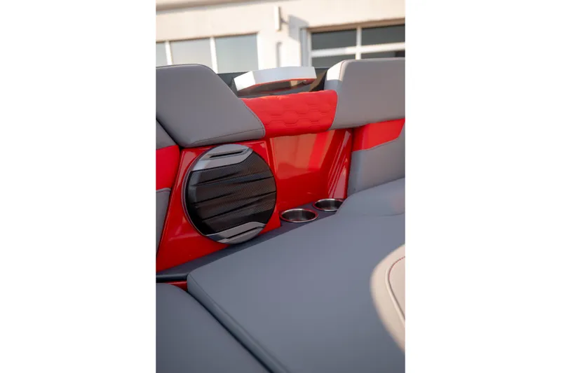 Slide: The Image of Interior of 2027 MasterCraft XT24 boat with red and gray seating, speaker, and cup holders. - 18
