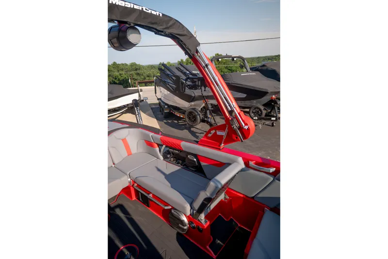 Slide: The Image of 2027 MasterCraft XT24 boat interior with red and gray seating, showcasing sleek design. - 21