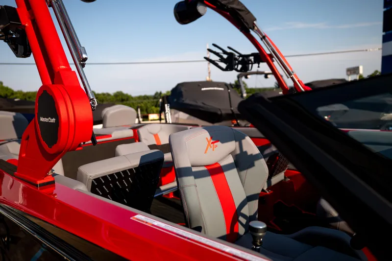 Slide: The Image of 2027 MasterCraft XT24 boat interior with red and gray seating, showcasing modern design. - 37