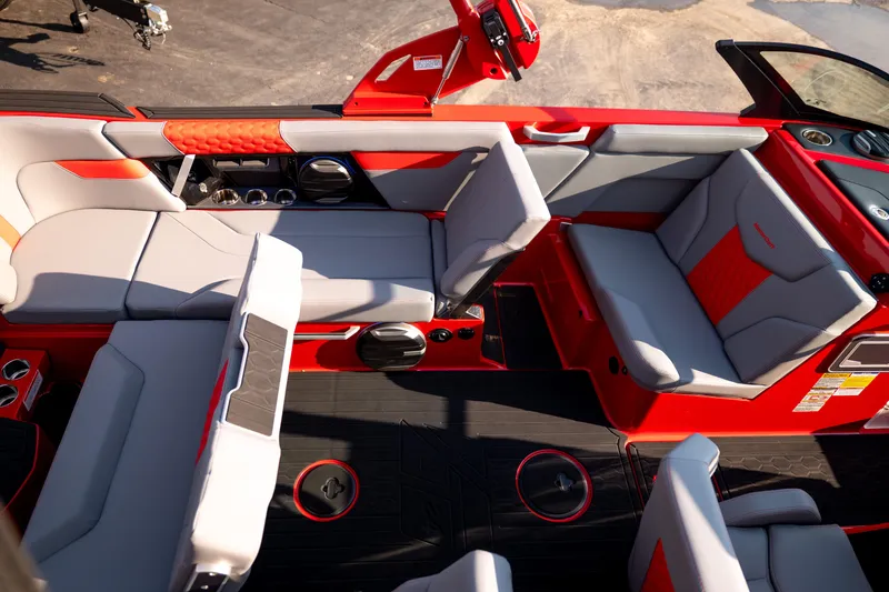 Slide: The Image of Interior of a 2027 MasterCraft XT24 boat with red and gray seating. - 32