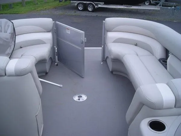 Slide: The Image of Interior of a 2017 Starcraft EX 23 C with gray upholstered seating and an open gate. - 4