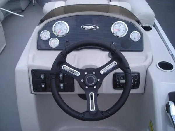 Slide: The Image of The image shows the helm of a 2017 Starcraft EX 23 C boat. - 3