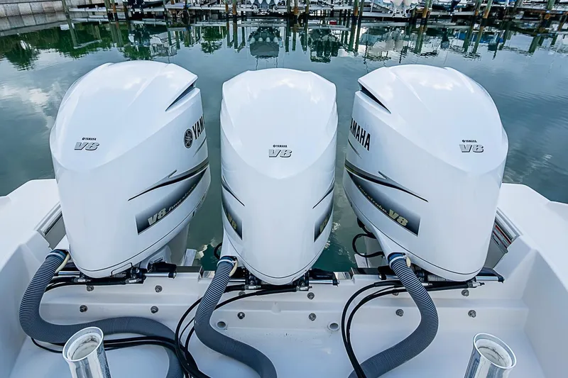 Slide: The Image of Triple Yamaha V8 engines on a 2020 Pursuit S 368 Sport boat at a marina. - 36