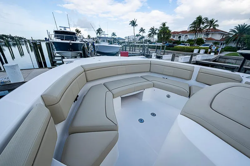 Slide: The Image of Luxurious seating on 2020 Pursuit S 368 Sport boat docked at marina. - 38