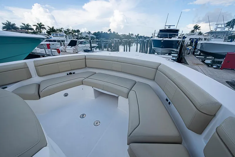 Slide: The Image of Luxurious seating area on a 2020 Pursuit S 368 Sport boat docked at a marina. - 39