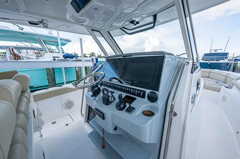 Slide: The Image of 2020 Pursuit S 368 Sport boat cockpit with advanced navigation controls and luxurious seating. - 22
