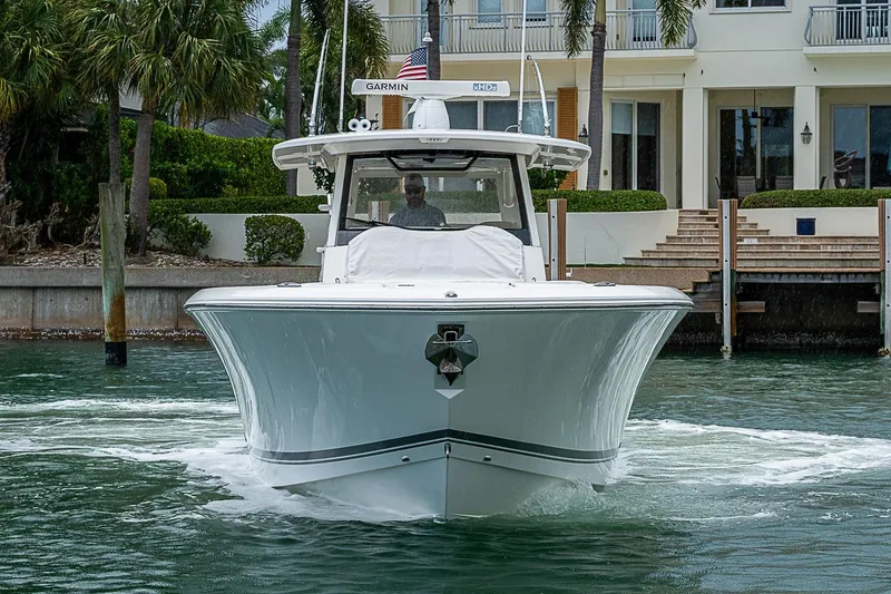 Slide: The Image of 2020 Pursuit S 368 Sport boat cruising near waterfront property. - 7
