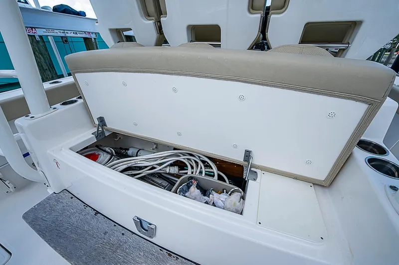Slide: The Image of Storage compartment on a 2020 Pursuit S 368 Sport boat, open with equipment inside. - 34