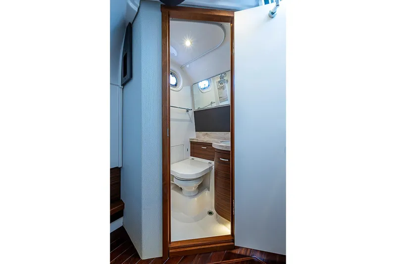 Slide: The Image of 2020 Pursuit S 368 Sport boat interior bathroom with modern fixtures and wooden cabinetry. - 45