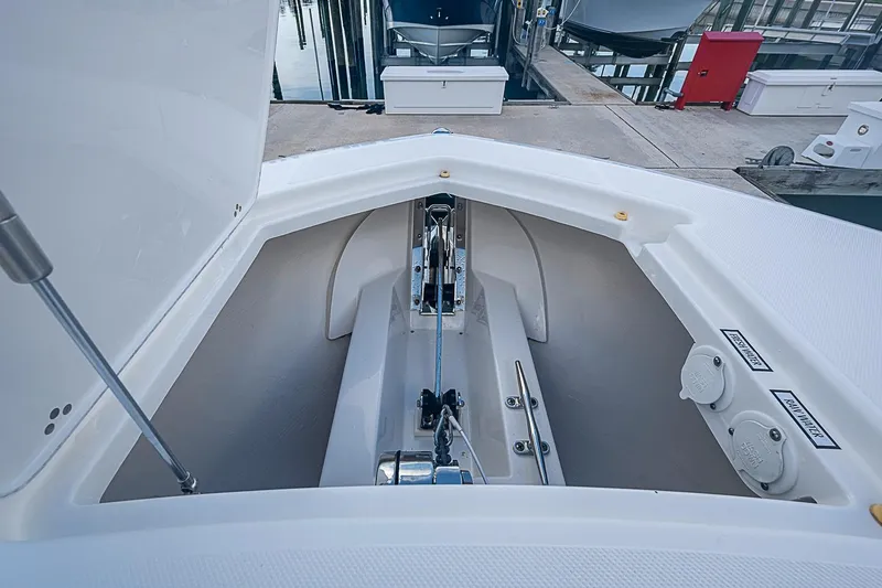 Slide: The Image of 2020 Pursuit S 368 Sport boat anchor compartment at marina dock. - 40