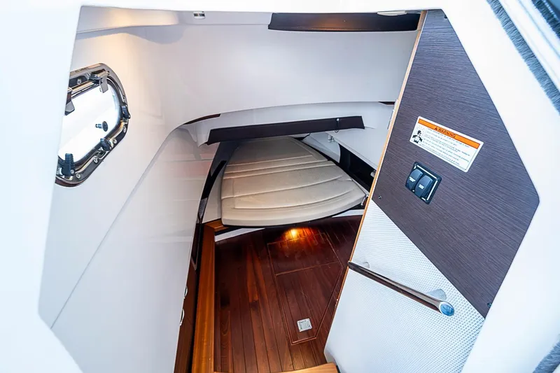 Slide: The Image of Interior cabin of 2020 Pursuit S 368 Sport boat with wooden flooring and cushioned seating. - 48