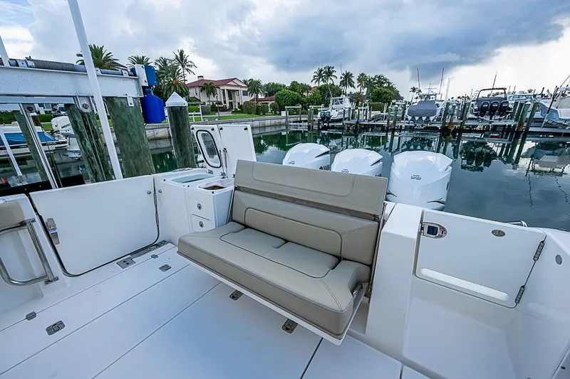 Slide: The Image of 2020 Pursuit S 368 Sport boat with seating, docked at marina under cloudy sky. - 30