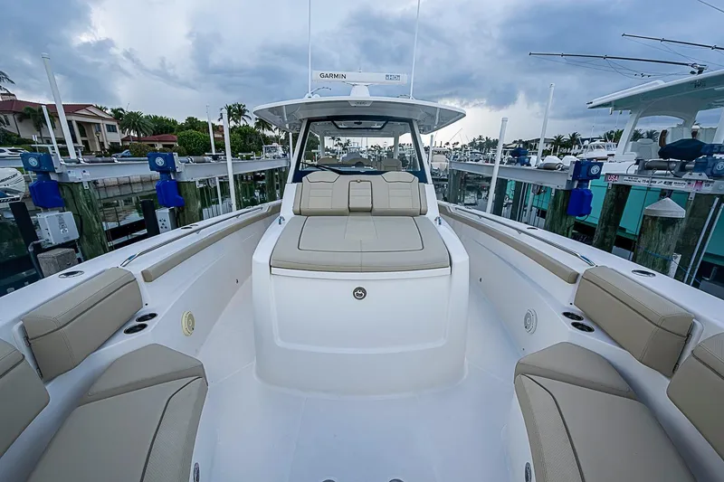Slide: The Image of 2020 Pursuit S 368 Sport boat with spacious seating at a marina dock. - 41