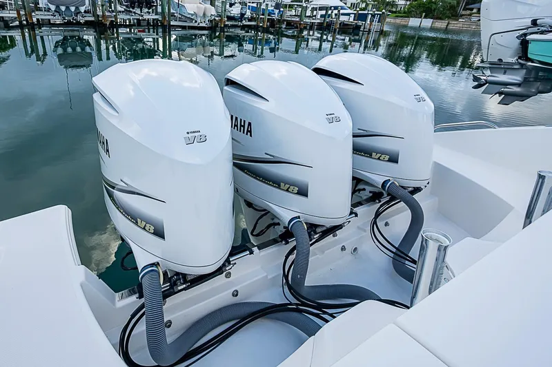 Slide: The Image of Triple Yamaha V8 engines on a 2020 Pursuit S 368 Sport boat at a marina. - 37